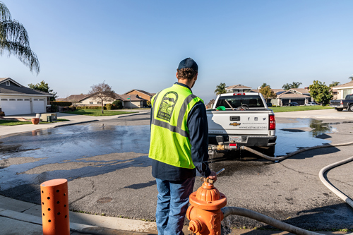 District staff flushing a fire hydrant to maintain keep pipes free of debris.