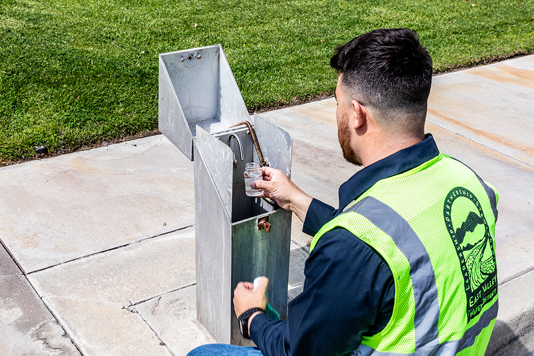 Photo of water quality sample taking place at District site. 